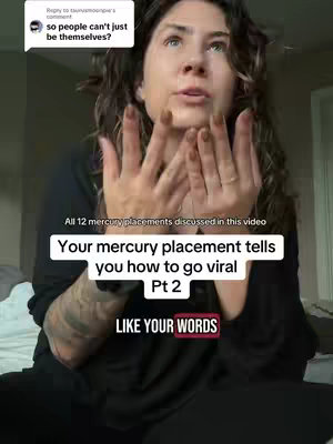 A woman with curly hair and a black top is shown in a selfie-style shot. The background is a blurred room. Text overlays read: 'Your mercury placement tells you how to go viral Pt 2' in a white box and 'LIKE YOUR WORDS' inside a red box.