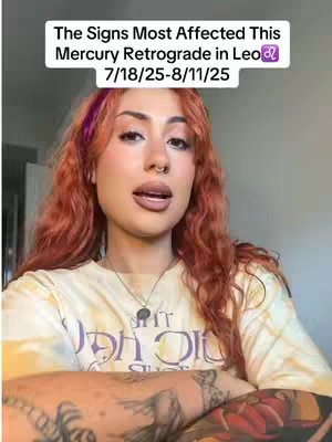 A woman with red hair and a tie-dye shirt is centered in the frame, with a white box overlay at the top containing text. The woman is looking at the camera while talking