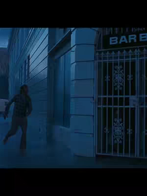A blurry, dark image of a man running on the street. Behind him are buildings and a gate with the word 'BAR' in print.