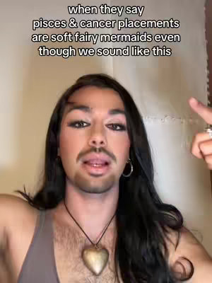 A selfie-style video cover image featuring a person with long dark hair, full makeup, and a heart pendant necklace. Text is overlaid at the top.