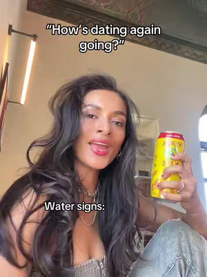 A woman with long, dark wavy hair holds a soda can with one hand and has her mouth open slightly. Text overlays state, “How’s dating again going?” and “Water signs:”.