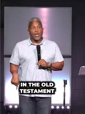 A man with gray hair and a light blue shirt speaks in front of a stage. On the bottom of the image is a black text overlay with the words 'IN THE OLD TESTAMENT'.