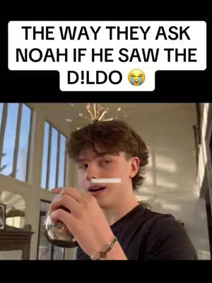 The cover image shows a young man with short, dark hair holding a clear glass with a liquid inside, possibly a beverage. His face is the focus. A text overlay in a black rectangle states, "The way they ask Noah if he saw the dildo," with an emoji representing crying. The background appears to be a well-lit interior, possibly a home, with windows and architectural details visible.