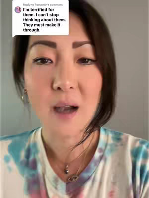 A close-up shot of a woman's face, with dark brown hair, and a colorful tie-dye shirt. A text box over her left shoulder has commentary.