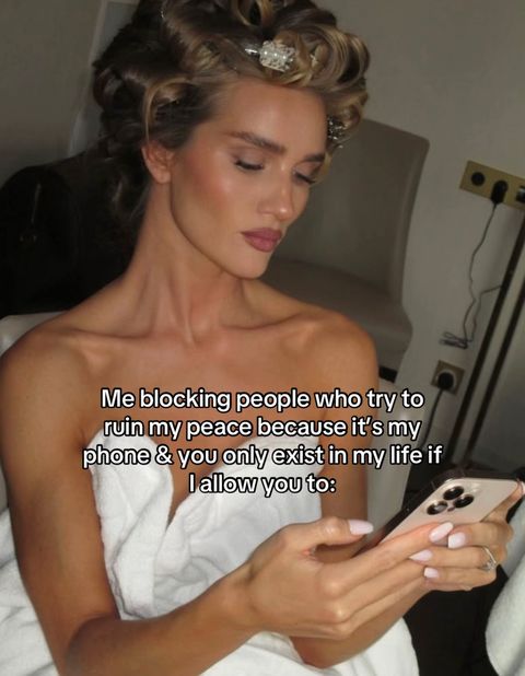 The image showcases a woman with styled, rolled hair, wearing a white towel. She is holding a phone and looking down at the screen. Text overlays are present, adding context to the image. The lighting suggests a relaxed indoor setting.