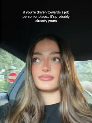 A young woman with long, highlighted brown hair sits in the driver's seat of a car, looking up and to the side with a thoughtful expression. Text overlays the image.