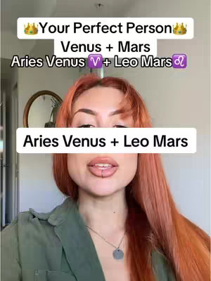 A woman with red hair is centered in the frame, with overlay text. The text reads, "Your perfect person, Venus + Mars, Aries Venus + Leo Mars." The woman has a lip ring and is wearing a green shirt. Behind her is a blurred interior with a wall and a circular mirror.