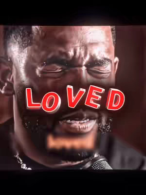 The cover image features a close-up of a man with a dark complexion, with the word 'LOVED' in large, red, outlined text overlaid on his face. His eyes are closed, conveying emotion, and his expression suggests intensity. Background lighting is dim, creating shadows.