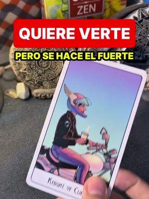The cover image shows a tarot card positioned at an angle towards the viewer. The card illustration features a person riding a motorcycle. The card is being held by a hand in the lower right corner. A red banner displays the text 'QUIERE VERTE'. Below that, 'PERO SE HACE EL FUERTE' is displayed on a yellow banner.