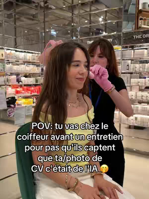 A woman is getting her hair styled by a stylist in a salon. Text overlay suggests the video is about getting a haircut before a job interview to avoid the interviewer realizing her CV photo was AI generated.
