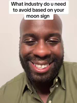 Image features a close-up shot of a Black man with a partially shaved head, smiling broadly. He's wearing a green collared shirt. Above his head is text: 'What industry do u need to avoid based on your moon sign'. The background is plain.