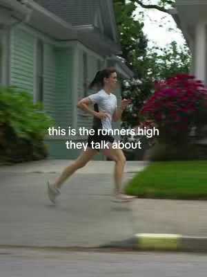 A woman running on a paved path next to houses and greenery is shown in motion. The text "this is the runners high they talk about" is overlaid on the image.