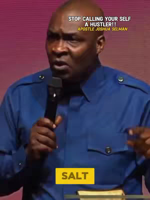 A man in a blue shirt speaks into a microphone, with text overlayed on the image.