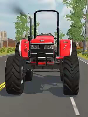 A close-up shot of a red tractor driving down a paved road. The tractor is facing the camera, with large black tires and a black front guard. The road has a white lane marker. In the background, there are green trees and a building visible.