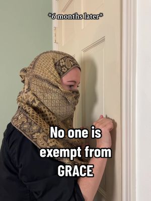 A person wearing a headscarf stands next to a white door, knocking. Text overlayed reads, "No one is exempt from GRACE."