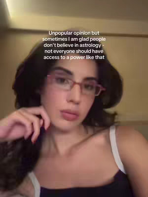 A woman with dark hair and glasses looks towards the camera; the quote is overlaid on her face.