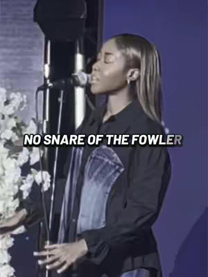 The cover image shows a woman in a performance setting, appearing to sing into a microphone. She is dressed in a black shirt and jeans jacket, with long hair. The text overlay reads "NO SNARE OF THE FOWLER". The background features a subtle blue color, and the overall composition suggests a worship or music-related theme.