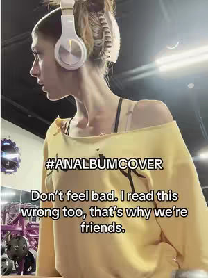 The image shows a young woman in profile wearing a yellow off-the-shoulder top and white headphones. She is in a gym setting, with exercise equipment visible in the background. Text overlays are added to the image.