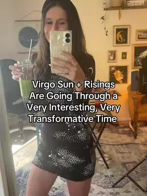 A woman is taking a selfie in a mirror, she's holding a phone in front of her in one hand. The background has art on the walls and furniture. There is text overlayed on the photo with a white font.