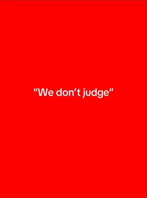 A simple image with a bright red background. White text in the middle says "We don't judge" enclosed in quotation marks.