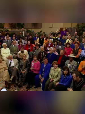 The cover image features a large group of people, likely in a theater or studio setting. The composition shows a wide shot emphasizing the diversity of the group. The colors are muted with a focus on the individuals’ attire and the setting's background. The layout is a medium shot filled with the subjects.