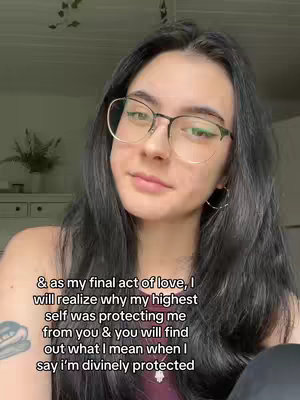 A selfie-style shot featuring a young woman with dark hair and glasses. She's looking slightly off-camera with a neutral expression. Overlayed on the image is text in a handwritten style.