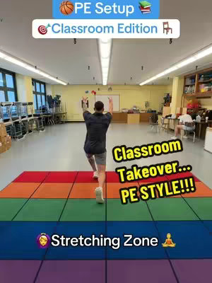 A classroom converted into a gym, featuring a man throwing balls in the center of the multi-colored mat, and playful text overlays at the top and bottom, hinting at a PE transformation.