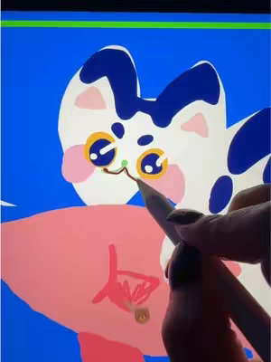 The cover image displays a digital drawing in progress on a tablet. A stylized cat with large, yellow eyes and blue and white fur is featured, against a bright blue background. The hand holding a stylus is visible, actively drawing and is adding to the design. The style is illustrative and playful.