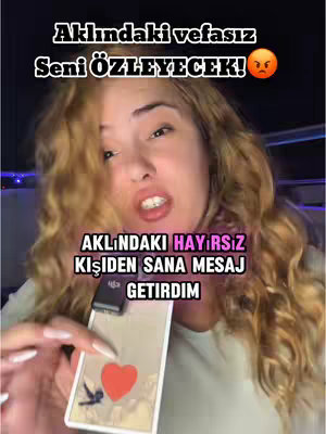 A medium shot features a woman with blonde, wavy hair, looking directly at the camera. She is holding a tarot card with a red heart and a bird illustration. Text overlays appear above. The color scheme includes warm tones.