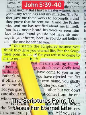An open Bible with a highlighted passage from John, with text overlays highlighting a quote. A yellow highlighter emphasizes the Bible verses. The background is a textured page with faint text, a fragment of a hand is visible with a yellow highlighter over the script.
