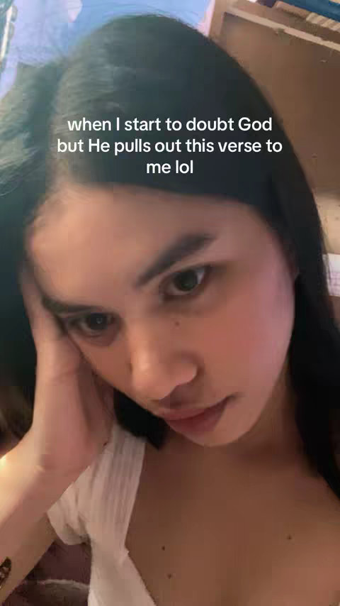A selfie showing a young woman in a close-up shot, angled slightly upwards. She has dark hair, her skin is a fair tone, and she's wearing a white top. She's resting her head on her hand with a thoughtful expression with a slightly emotional expression. Text overlayed on image.