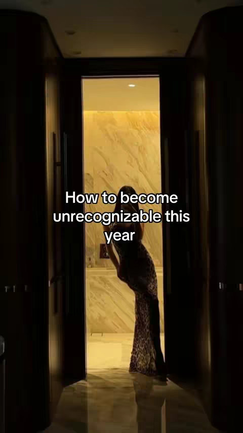 A woman in a leopard print dress stands in a doorway, framed by dark wooden panels. The background features a light-colored wall and floor. Text overlay reveals the words: "How to become unrecognizable this year."