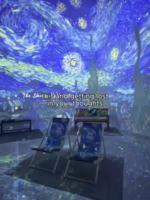 The image shows an indoor scene with projected visuals of Van Gogh's "Starry Night" painting on the ceiling. Two deck chairs with "Van Gogh" branding and a wooden bench are in the foreground. The text overlay reads: "The Star... this and getting lost in your thoughts."