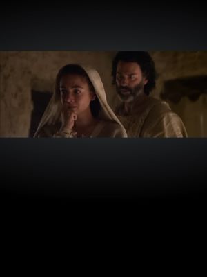The cover image presents a scene from a movie. Two persons are present, and the one in front is a woman wearing a white shawl, with her hand touching her chin, as if she is deep in thought. Behind her is a man with a beard. The background is dimly lit and appears to be inside.