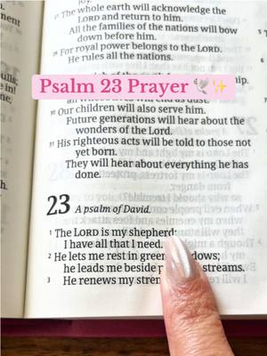 An open Bible is shown, with a finger pointing to verse 1 of Psalm 23. Overlayed text reads 'Psalm 23 Prayer' on a pink background.