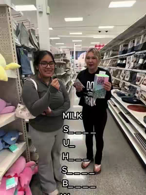 Two women stand in a Target aisle, one holding a box of a product and the other smiling. Text overlayed on the image spells out a word related to the store, with blanks.
