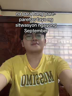 A young man wearing glasses and a yellow shirt with a design on it is centered in the frame, looking towards the camera. The text overlayed on the top mentions a shared situation this September.