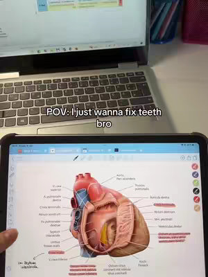 A person is holding a tablet displaying an anatomical illustration of a heart. The background includes a laptop displaying notes and a desk. The image has a medical and educational theme.