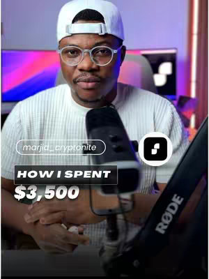 The cover image features a man in a white t-shirt and baseball cap, wearing glasses, and holding a microphone. Text overlays indicate the video's focus on his spending habits. The background includes a computer screen.