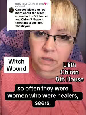 The cover image focuses on a woman with blonde hair and glasses. The layout includes overlay text boxes with the words "Witch Wound," "Lilith Chiron 8th House," and a black box containing the sentence, "so often they were women who were healers, seers," overlaid on the foreground. The background is a soft, light pink, with the woman wearing a matching pink shirt, and there's a suggestion of soft patterned fabric on the upper section of the background.