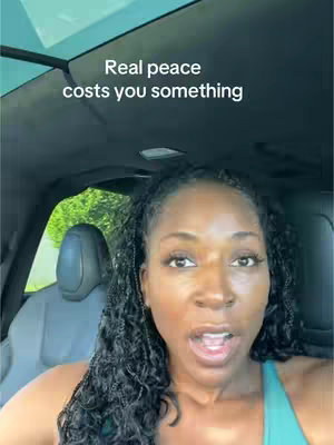 A woman with dark hair speaks directly to the camera from the driver's seat of a car. Text overlayed on the image states, 'Real peace costs you something.' The background shows greenery visible through the car window.