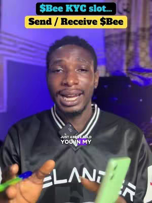 A medium shot features a Black man against a gradient purple and blue background. He is smiling and facing the camera with a green phone in his right hand. Text overlays are on top, and he wears a black and white collared shirt. The overall composition suggests a tech-related or informational video.