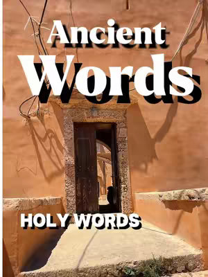 The cover image showcases a doorway with an open wooden door, revealing an arched passage within a building. The exterior walls are a warm orange-brown color, with shadows cast across the textured surface. The words 'Ancient Words' are stacked above the door, and 'Holy Words' is at the bottom, both in a bold, sans-serif font. The overall lighting suggests a sunny day.