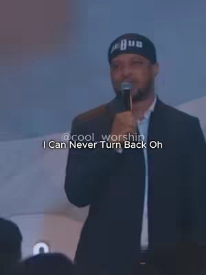 A man in a suit and a black beanie with the word 'JESUS' on it, speaking into a microphone. Text overlayed at the bottom reads '@cool_worship I Can Never Turn Back Oh'