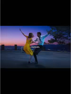 A still from the musical film La La Land. A man in a white shirt and black pants is dancing, facing a woman in a yellow dress. They're on a rooftop, with a cityscape and a colorful sunset in the background, with text saying "musicals."