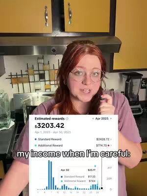 A woman with red hair and glasses is speaking to the camera in a kitchen. Overlayed on the woman is a screenshot of financial data, with a graph and numbers detailing financial rewards. Text at the bottom says, 'my income when I'm careful:' The kitchen has yellow cabinets and stainless steel appliances visible behind her.