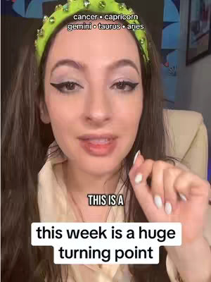 A selfie-style cover image shows a woman in a light-colored top with dark hair, wearing a green headband adorned with rhinestones. Text overlays include astrological signs at the top and a sentence at the bottom. The woman is looking towards the camera with a slight smile, and her right hand is raised with her index finger pointing upwards.