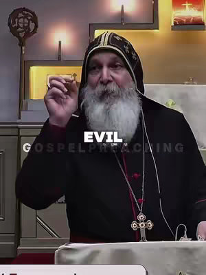 The image features a man with a long, white beard wearing a black religious garment and hat. Text overlays read 'EVIL' and 'GOSPEL PREACHING'. He holds a small cross and gestures as if speaking in front of a blurry backdrop. The scene is warm-toned, and the composition centers on the man, suggesting a focus on him and his words.