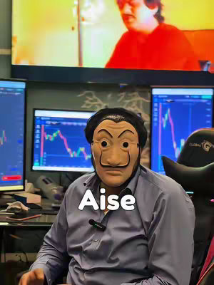 A man wearing a Salvador DalΓ-esque mask is centered in the frame, facing the viewer. Behind him are multiple computer screens displaying charts and graphs, suggesting a trading or finance-related context. The word "Aise" is overlaid in a white rounded font below the mask. The overall colors are muted, with a focus on the man and the data on the screens.