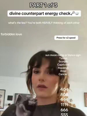 A woman with dark hair and makeup, positioned front-and-center, appears thoughtfully at the camera. Text overlays include the title "PART 1 of 3," a description of the topic (divine counterpart energy check), and other phrases and lists. The background is a softly lit room with hints of decor.